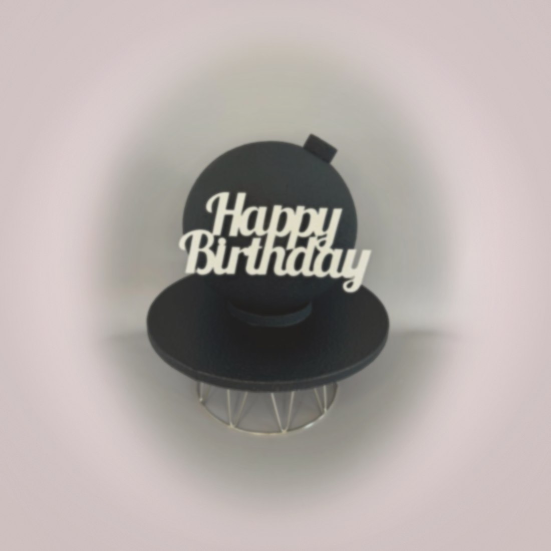 Black sphere cake with Happy Birthday topper