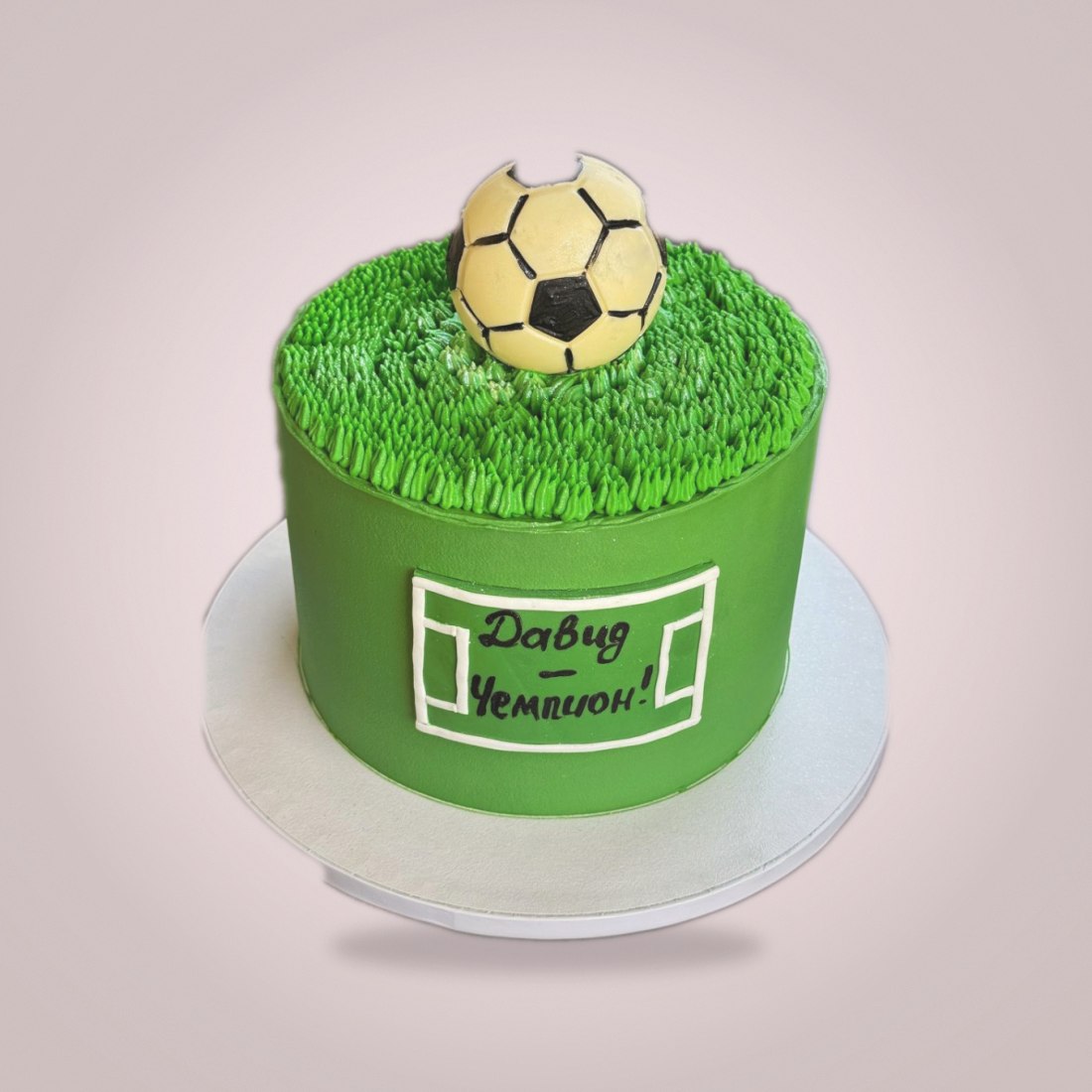 Football cake with grass and chocolate ball