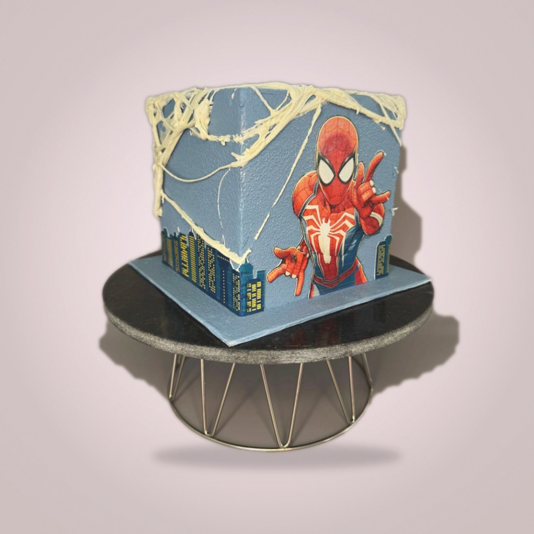 Themed cake with city skyline and superhero edible print
